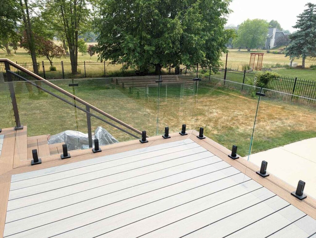 Glass railing and composite decking on a raised deck