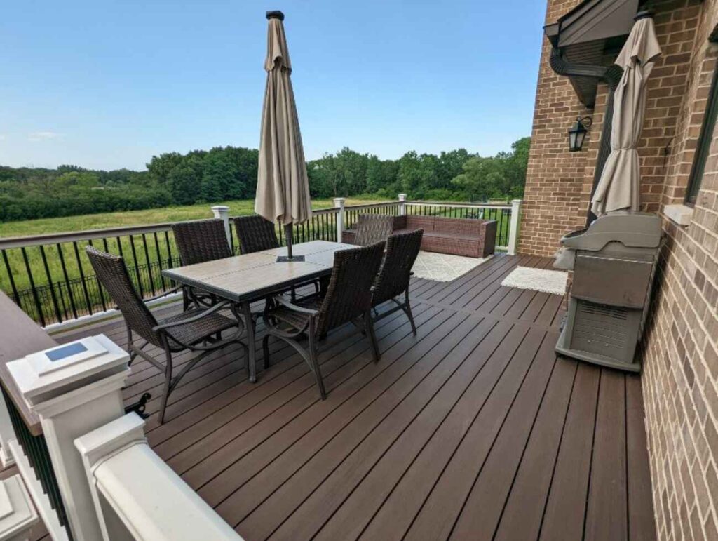 Upper deck dining area with white and black railing