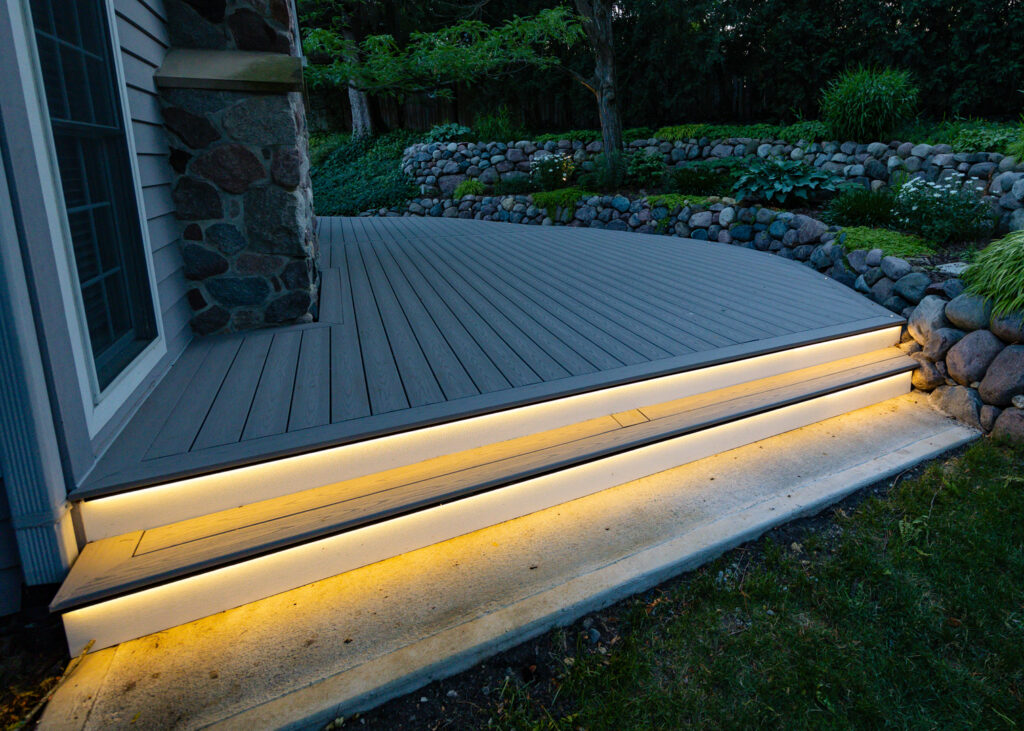Curved composite deck steps with lighting at dusk