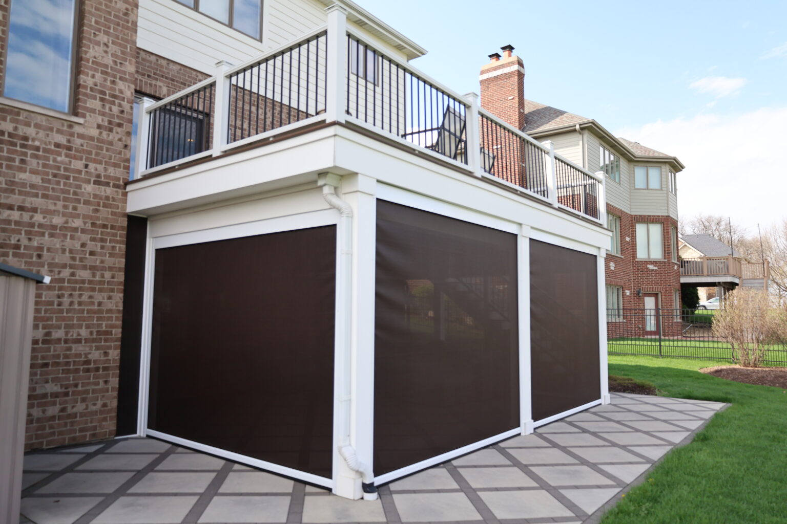 Elevated deck with the space underneath finished and enclosed with motorized screens