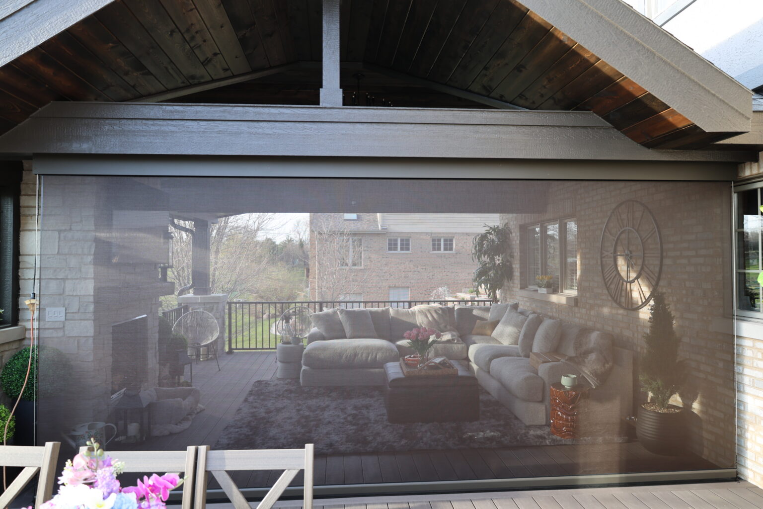 Screen fully lowered on a covered patio