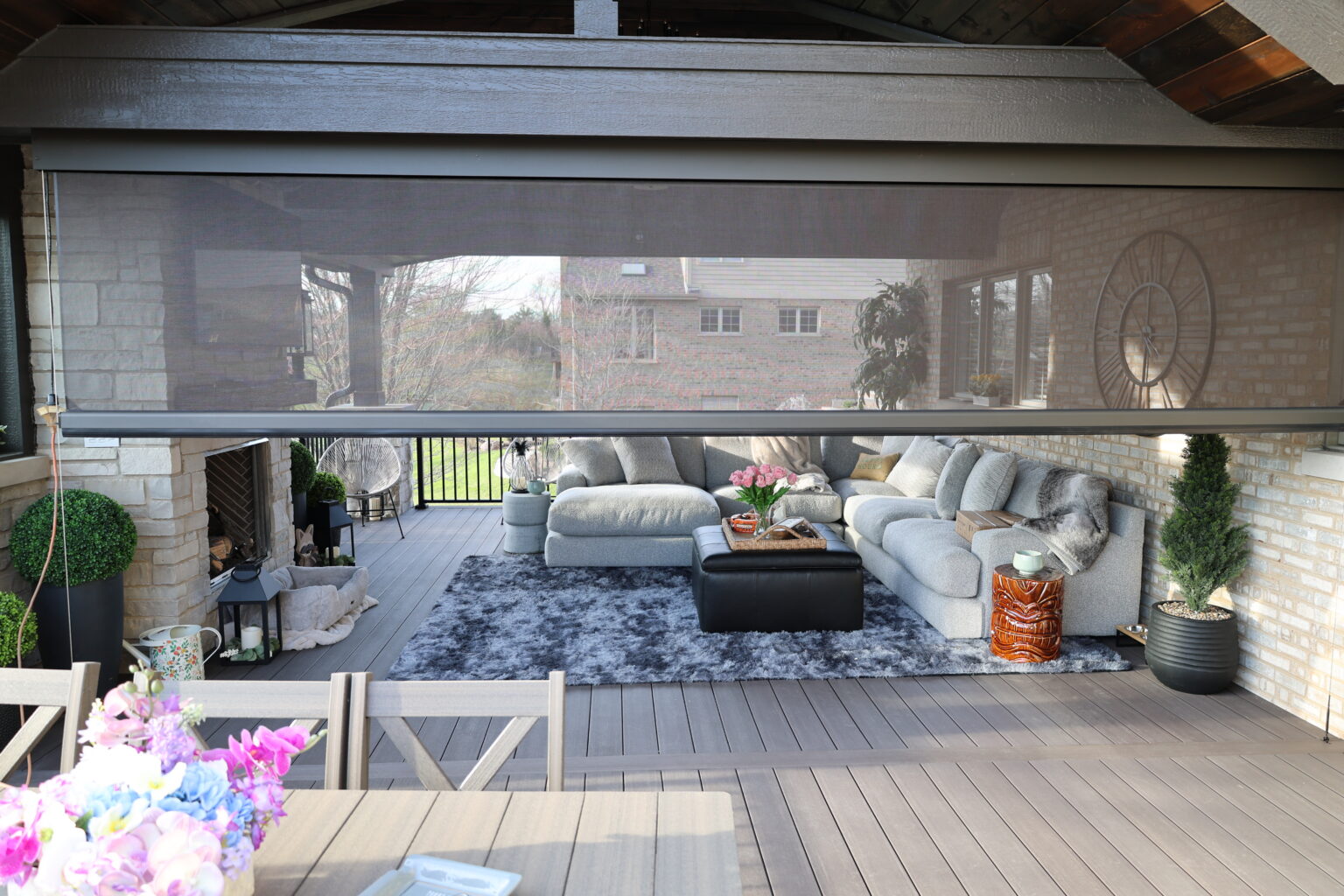Screen half down on a covered patio with seating