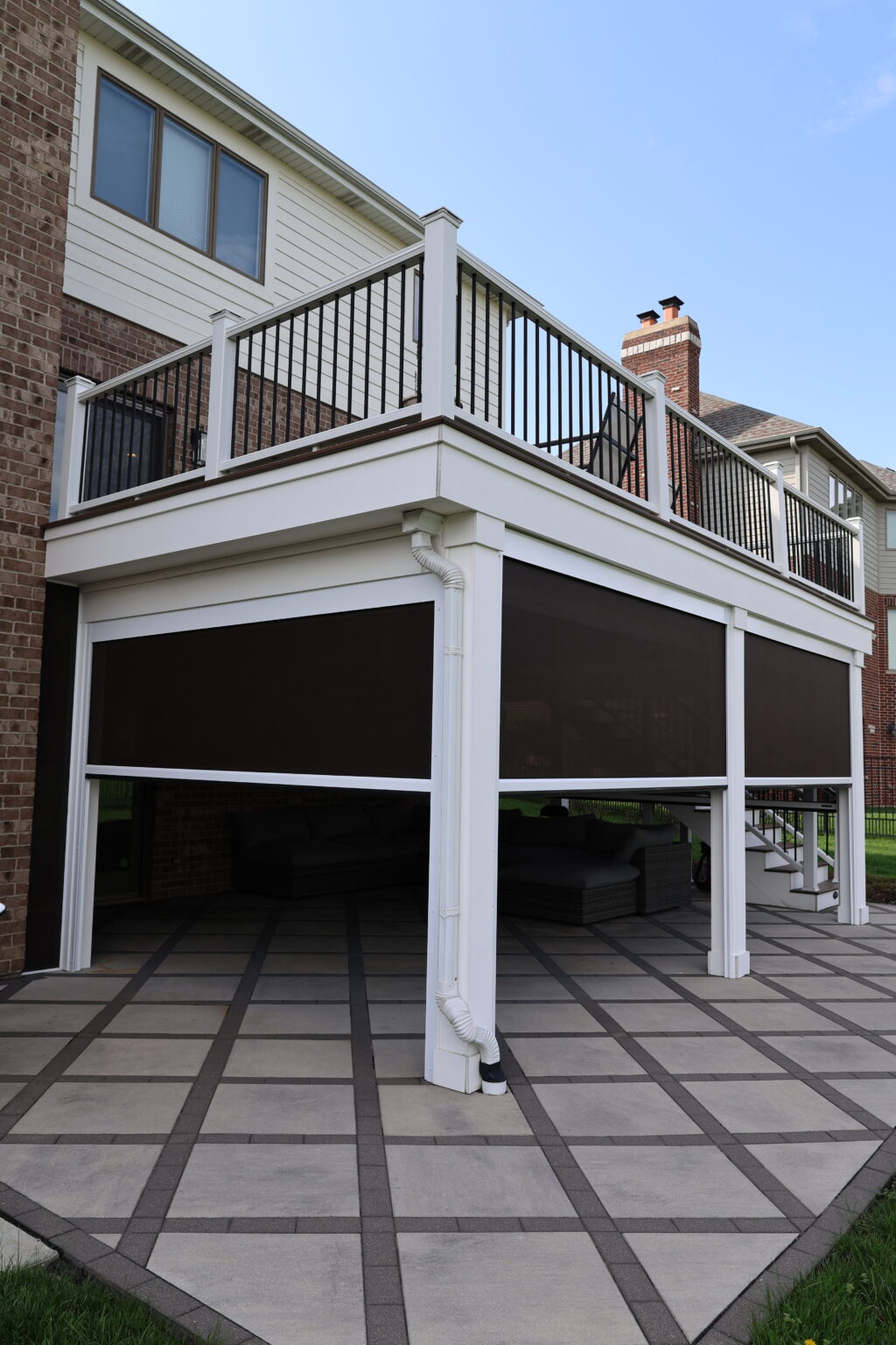 Screened space below a white deck