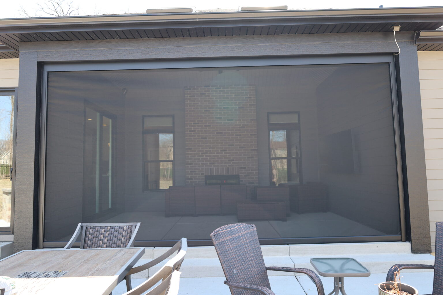 Screen closing a covered patio opening
